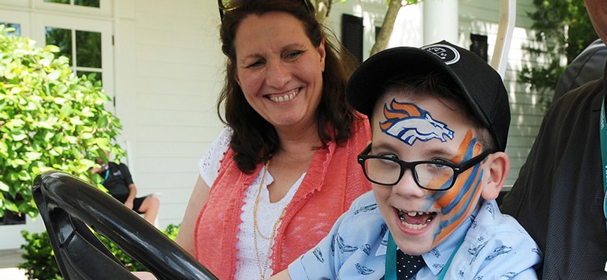 Ricky, a 9-year-old boy with cerebral palsy, sits in his special car seat.