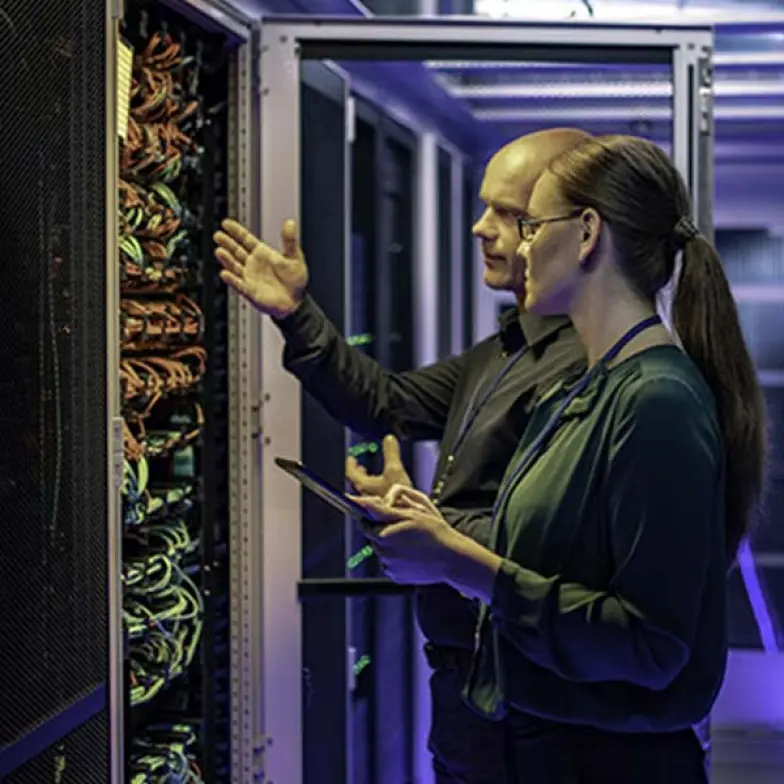 A gentleman and a lady working in the datacenter