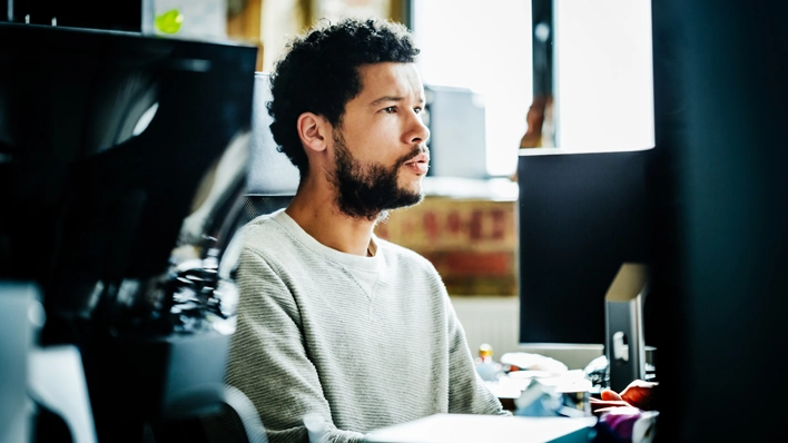 photo of man front of computer