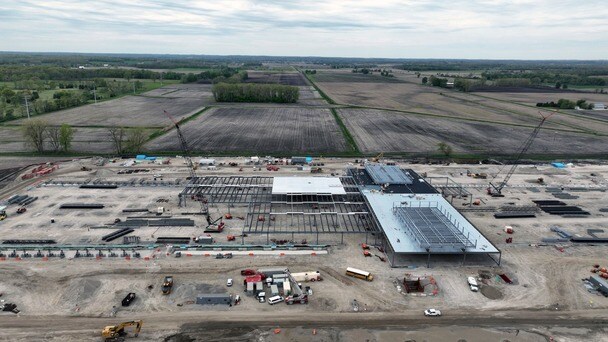 Aerial view of a building under construction on a large site