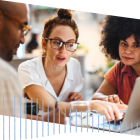 3 People working on a laptop at CloudWorld