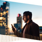 Person working on phone in front of skyscrapers