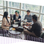 Four people sitting around table working
