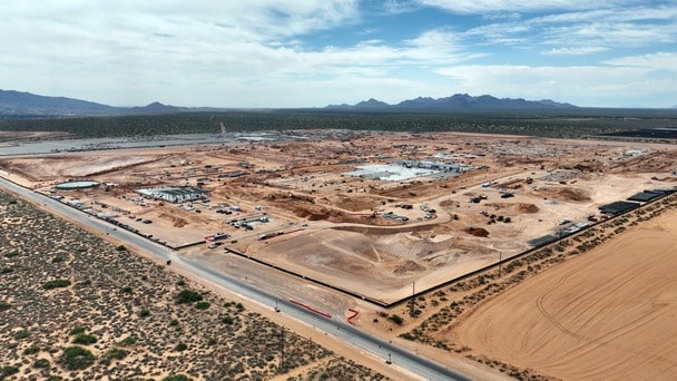 Aerial view of a large construction site in a desert landscape