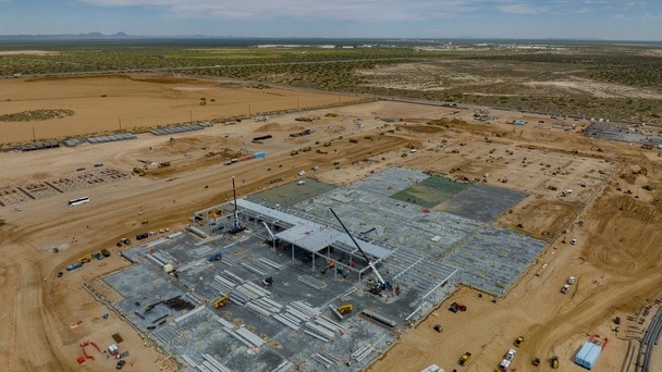 Aerial view of a large building construction site in a desert area