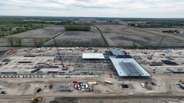 Aerial view of a building under construction on a large site