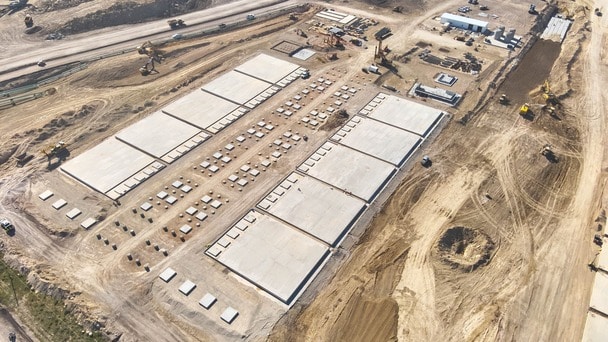 Aerial view of a construction site with large concrete foundations