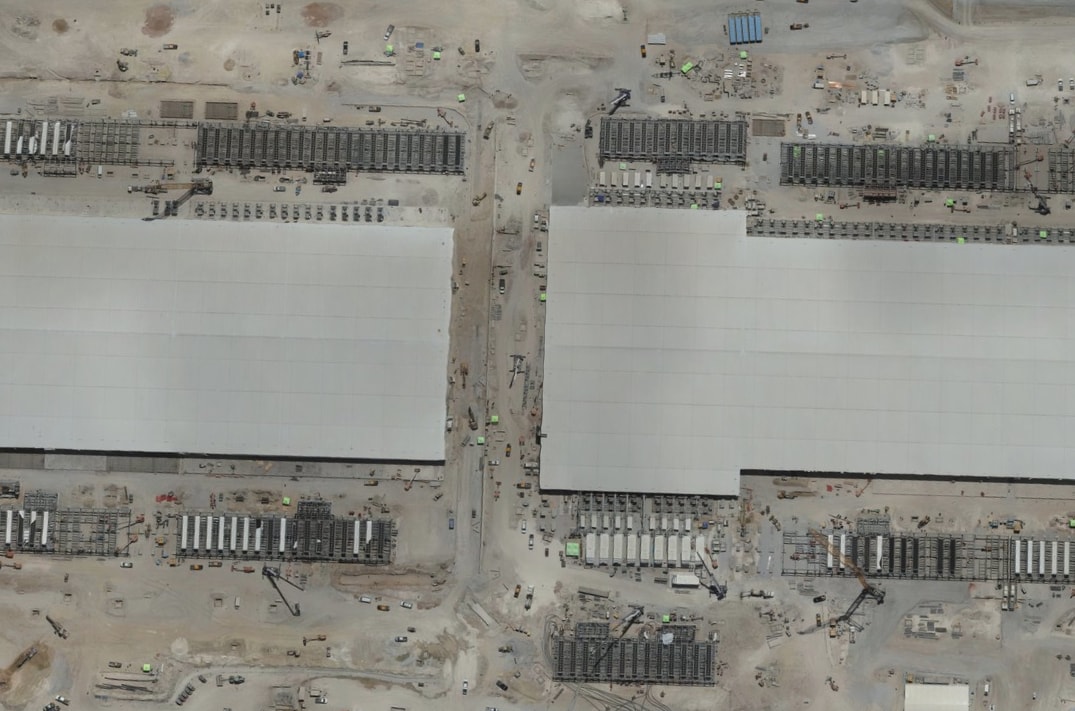 Aerial view of two large data hall buildings under construction